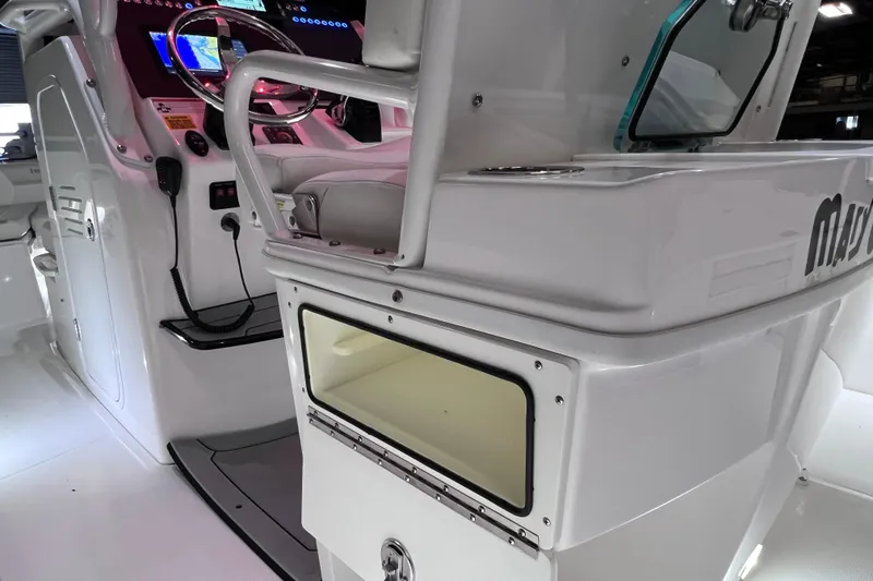 Slide: The Image of 2021 Everglades 253 Center Console boat interior with modern dashboard and storage compartment. - 33