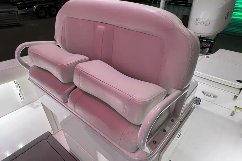 Slide: The Image of 2021 Everglades 253 Center Console boat seat with pink cushions and sturdy armrests. - 38