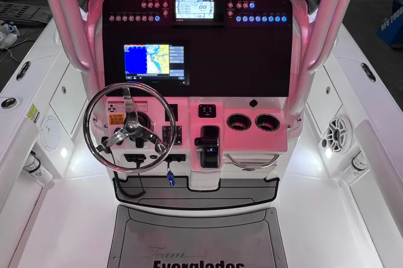 Slide: The Image of 2021 Everglades 253 Center Console boat dashboard with navigation screens and steering wheel. - 39