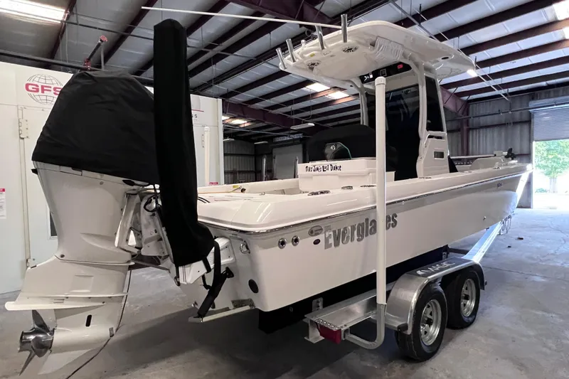 Slide: The Image of 2021 Everglades 253 Center Console boat on trailer in warehouse setting. - 4