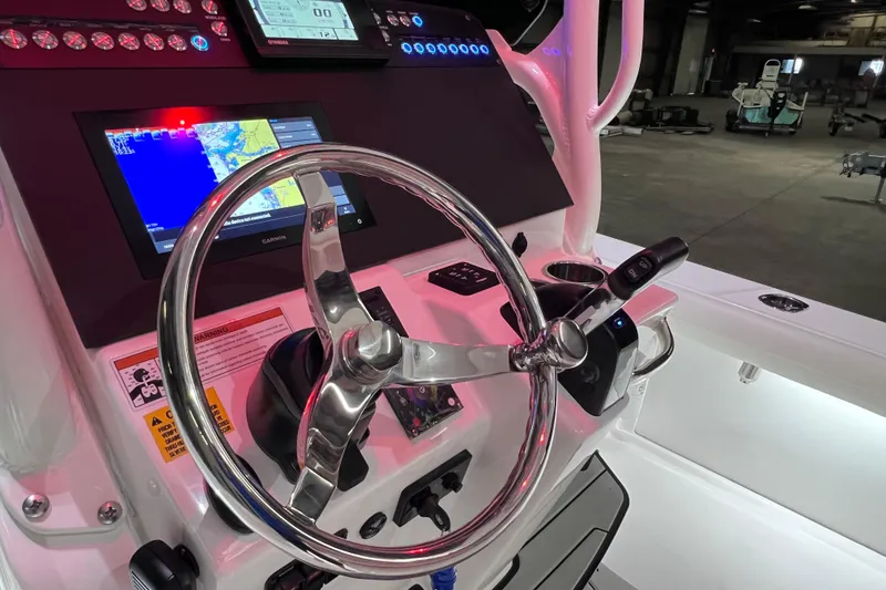 Slide: The Image of 2021 Everglades 253 Center Console boat dashboard with steering wheel and navigation screens. - 40
