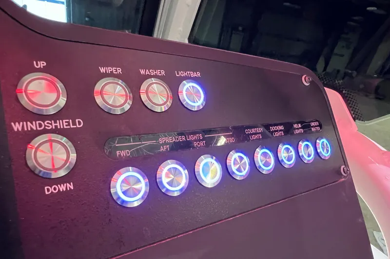 Slide: The Image of Control panel of a 2021 Everglades 253 Center Console boat with illuminated buttons. - 42