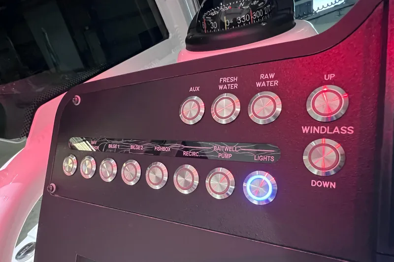 Slide: The Image of Control panel of 2021 Everglades 253 Center Console boat with illuminated buttons. - 43