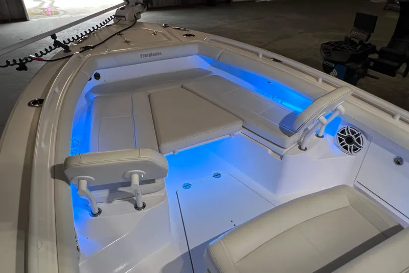 Slide: The Image of 2021 Everglades 253 Center Console boat interior with blue LED lighting and cushioned seating. - 50