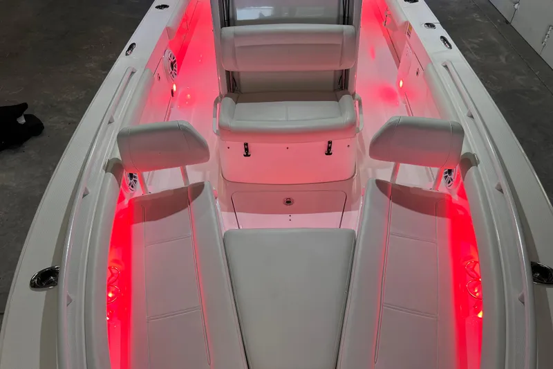 Slide: The Image of 2021 Everglades 253 Center Console boat interior with red LED lighting and white seating. - 56