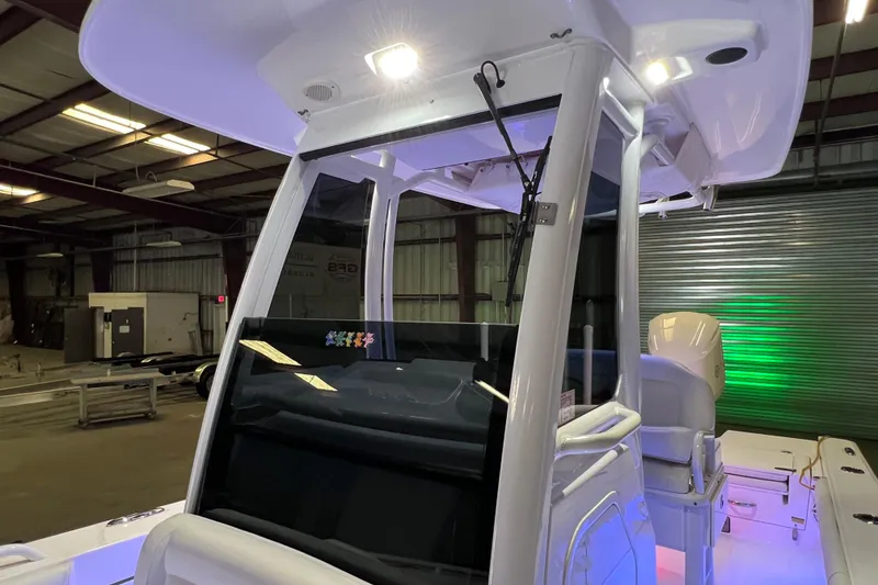 Slide: The Image of 2021 Everglades 253 Center Console boat interior with illuminated console and seating. - 60