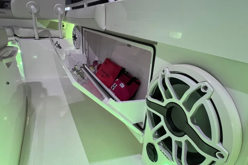 Slide: The Image of 2021 Everglades 253 Center Console interior with storage compartment and speaker system. - 64