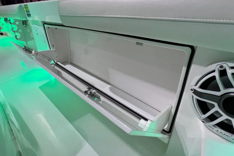 Slide: The Image of 2021 Everglades 253 Center Console boat storage compartment with green LED lighting. - 65