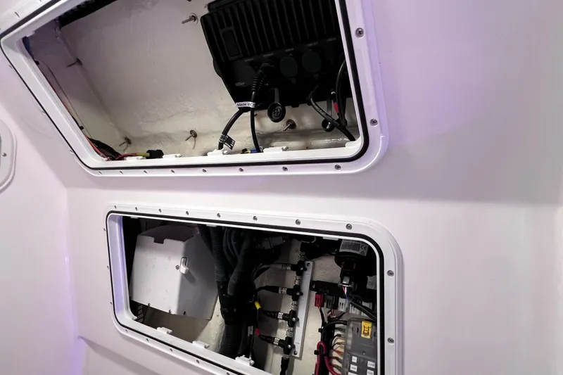 Slide: The Image of 2021 Everglades 253 Center Console boat compartments with wiring and equipment. - 69