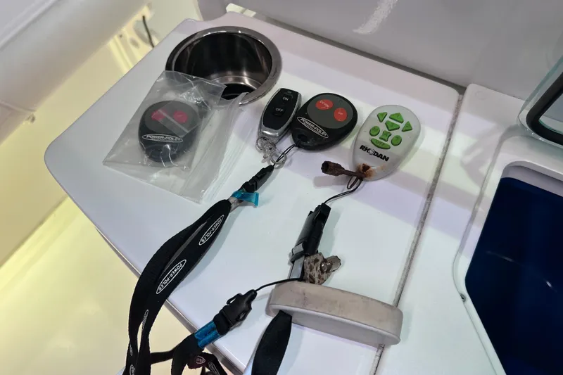 Slide: The Image of Boat console with remote controls and lanyards, Everglades 253 Center Console 2021. - 78