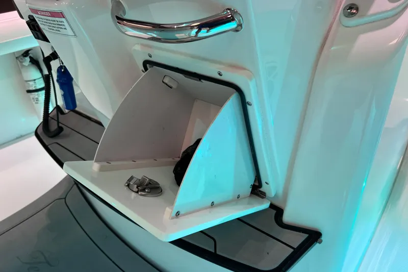Slide: The Image of 2021 Everglades 253 Center Console boat storage compartment with handle and latch. - 79