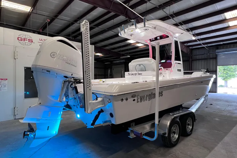 Slide: The Image of 2021 Everglades 253 Center Console boat with Yamaha engine in a garage setting. - 8