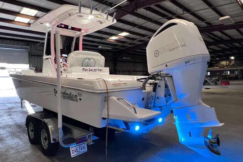 Slide: The Image of 2021 Everglades 253 Center Console boat with Yamaha engine in a warehouse setting. - 9