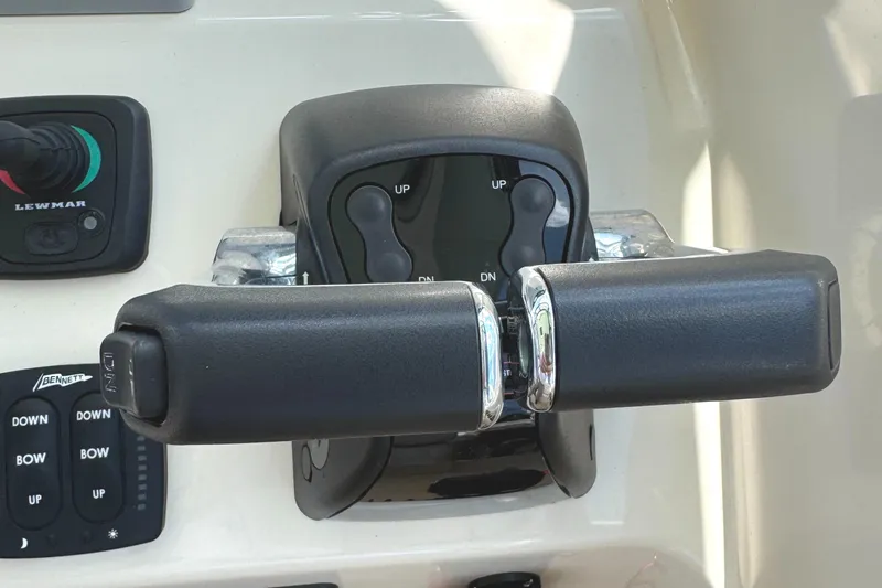 Slide: The Image of Throttle controls on a 2018 Grady-White Freedom 307 boat dashboard. - 10