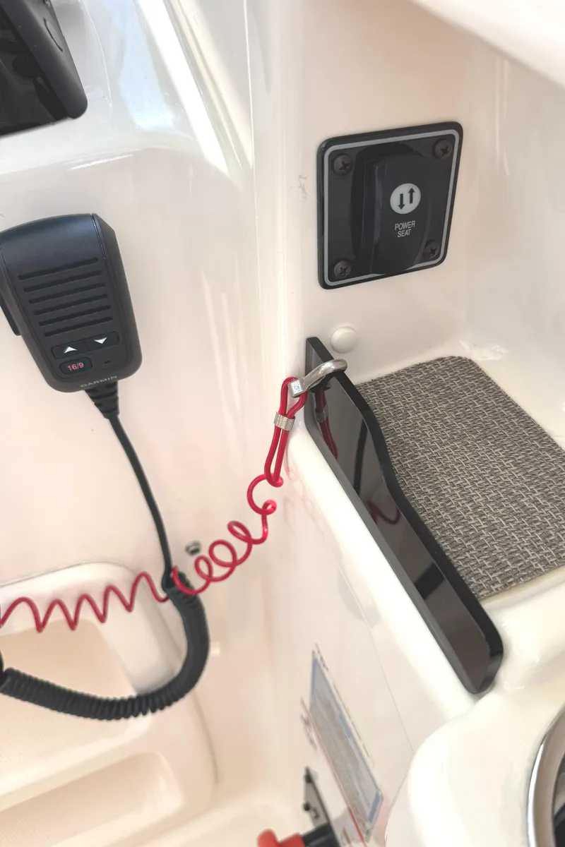 Slide: The Image of 2018 Grady-White Freedom 307 boat interior with safety lanyard and communication device. - 12