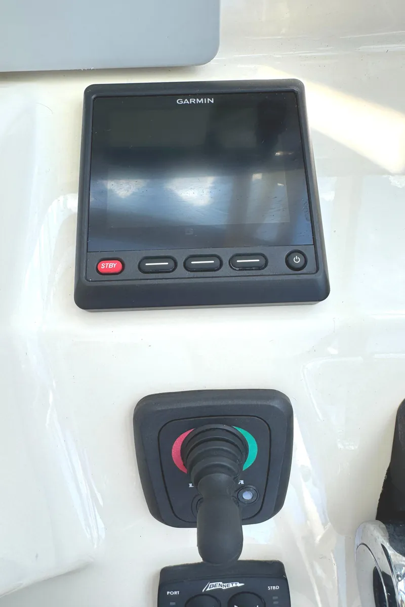 Slide: The Image of Garmin display and controls on 2018 Grady-White Freedom 307 boat dashboard. - 13