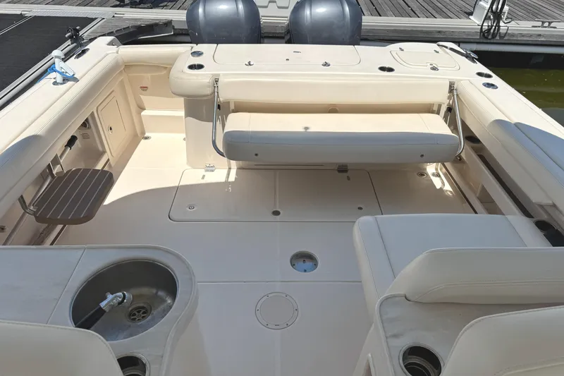 Slide: The Image of 2018 Grady-White Freedom 307 boat interior with seating and sink, docked at marina. - 14