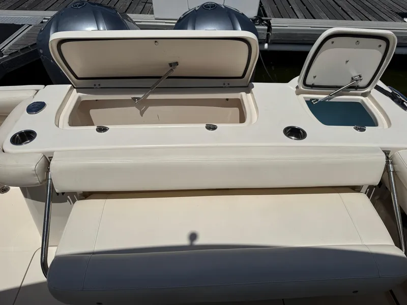 Slide: The Image of 2018 Grady-White Freedom 307 boat with open storage compartments and seating. - 15