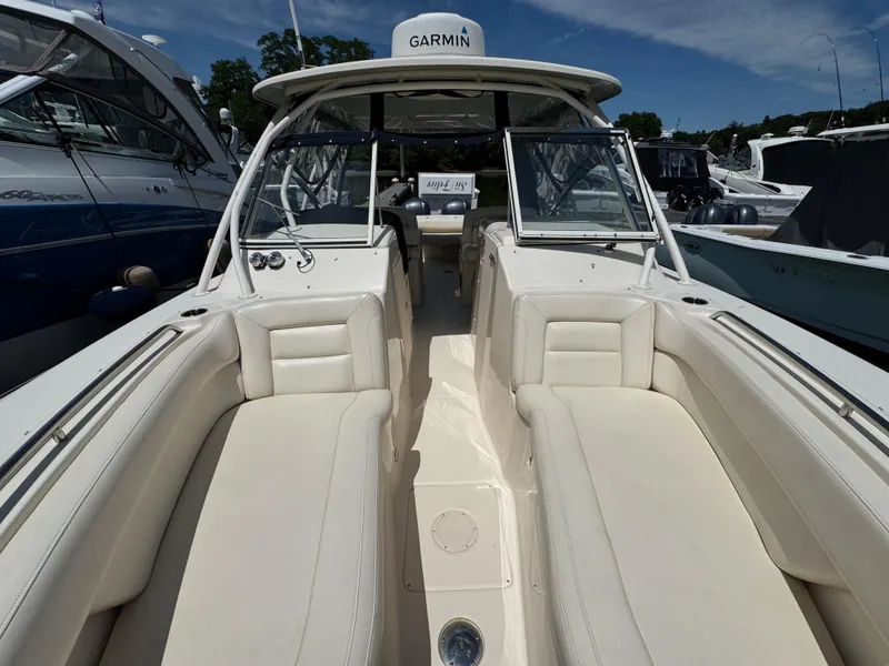 Slide: The Image of 2018 Grady-White Freedom 307 boat interior with white seating and Garmin equipment. - 18