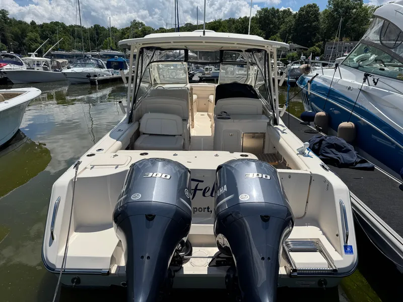 Slide: The Image of 2018 Grady-White Freedom 307 boat with twin Yamaha 300 engines docked at marina. - 2