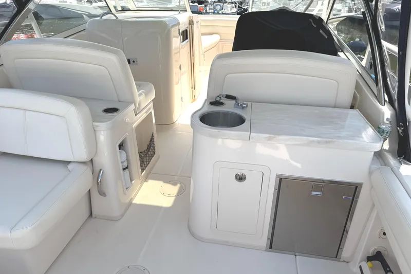 Slide: The Image of 2018 Grady-White Freedom 307 boat interior with seating and kitchenette area. - 21