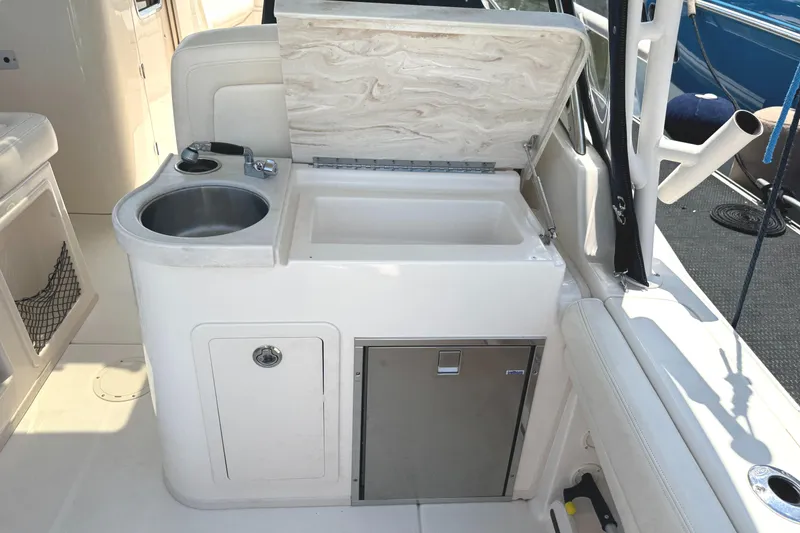 Slide: The Image of 2018 Grady-White Freedom 307 boat interior with sink and storage area. - 22