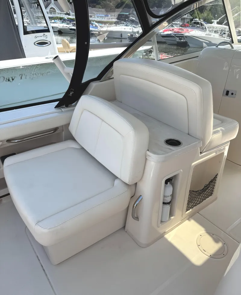 Slide: The Image of 2018 Grady-White Freedom 307 boat interior with white seating and storage compartments. - 25