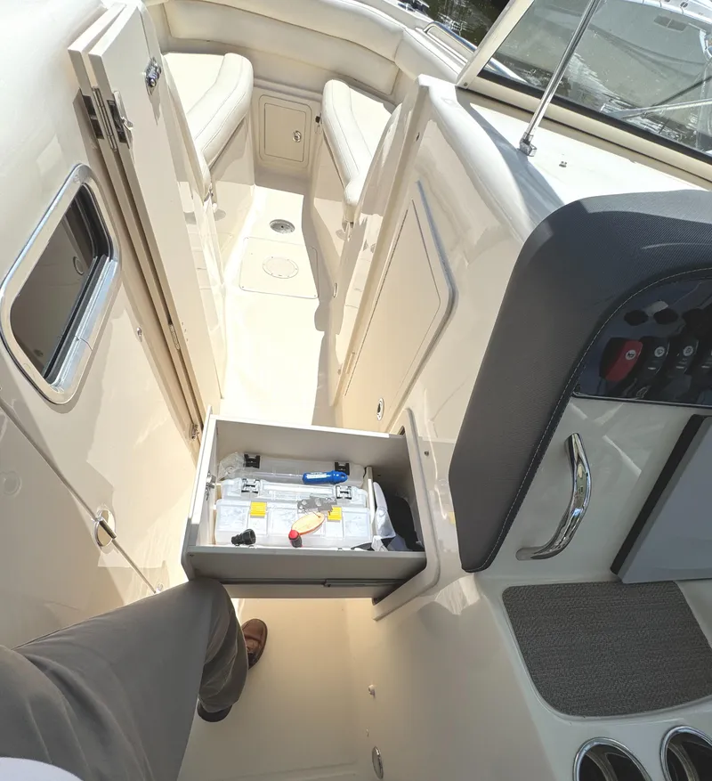 Slide: The Image of 2018 Grady-White Freedom 307 boat interior with open storage compartment. - 27