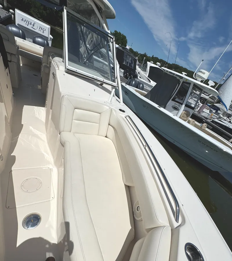 Slide: The Image of 2018 Grady-White Freedom 307 boat interior with seating, docked at marina. - 29