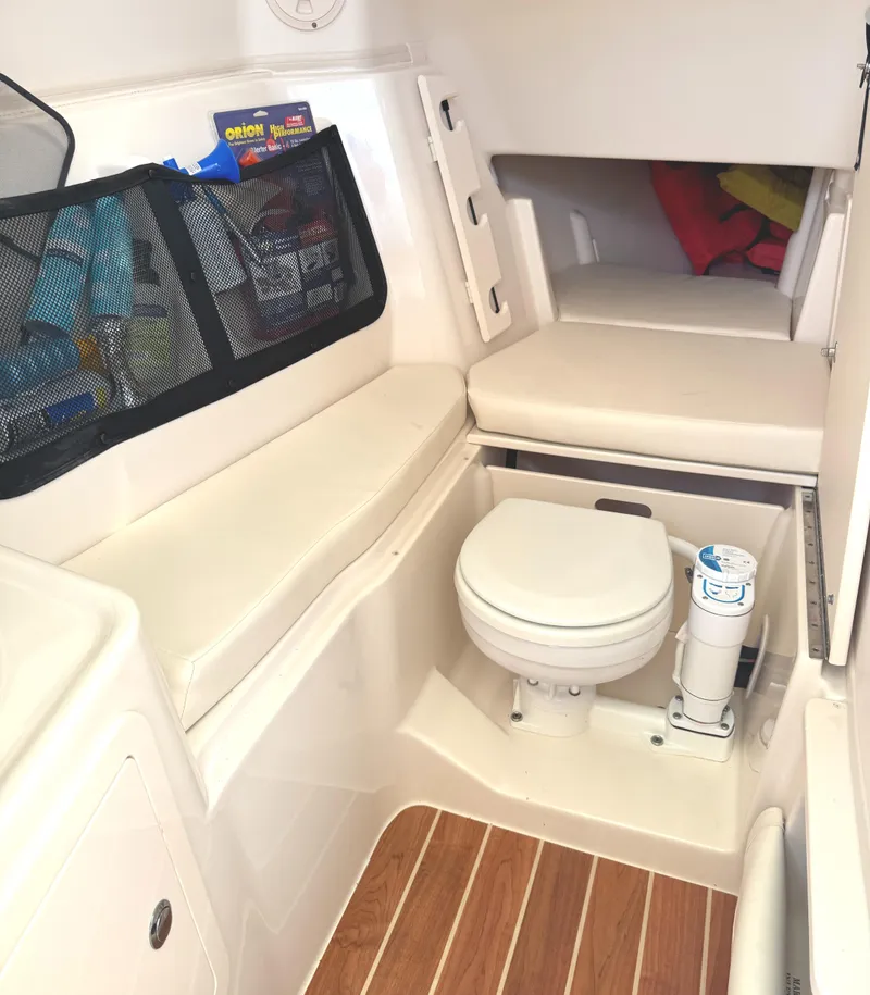 Slide: The Image of 2018 Grady-White Freedom 307 boat interior with toilet and storage area. - 31