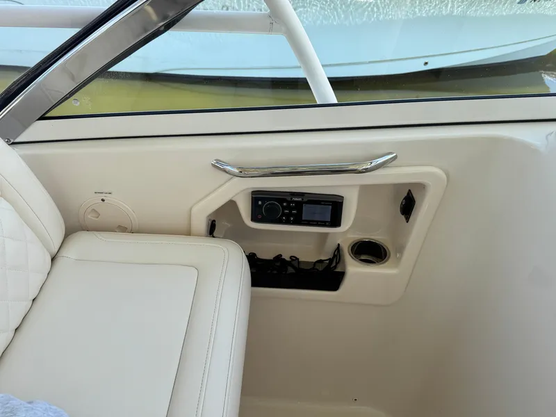 Slide: The Image of 2018 Grady-White Freedom 307 boat interior with radio and cup holder. - 35