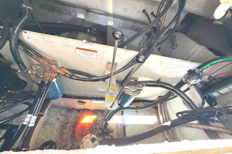 Slide: The Image of Engine compartment of 2018 Grady-White Freedom 307 boat, showing wiring and mechanical components. - 45