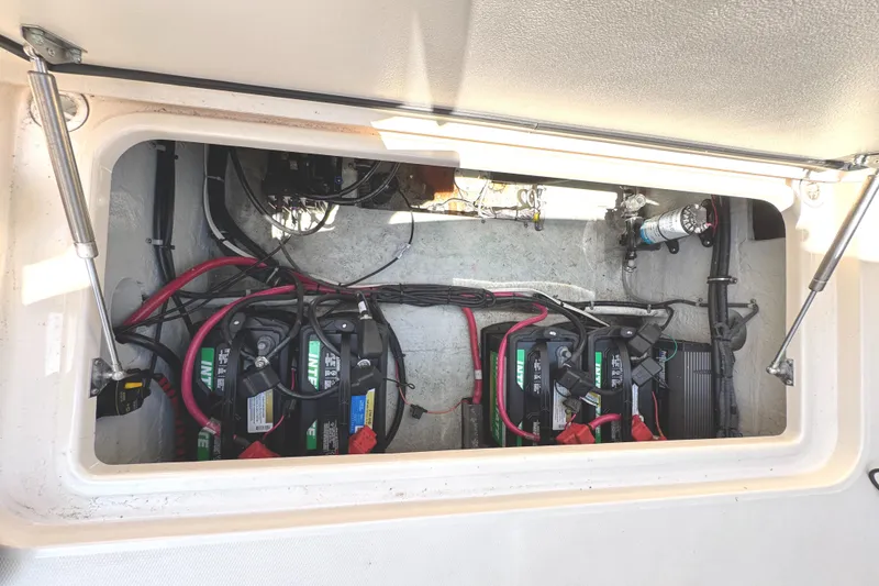 Slide: The Image of 2018 Grady-White Freedom 307 boat battery compartment with wiring and components. - 46