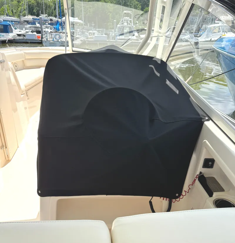Slide: The Image of 2018 Grady-White Freedom 307 boat interior with covered equipment, docked at marina. - 5