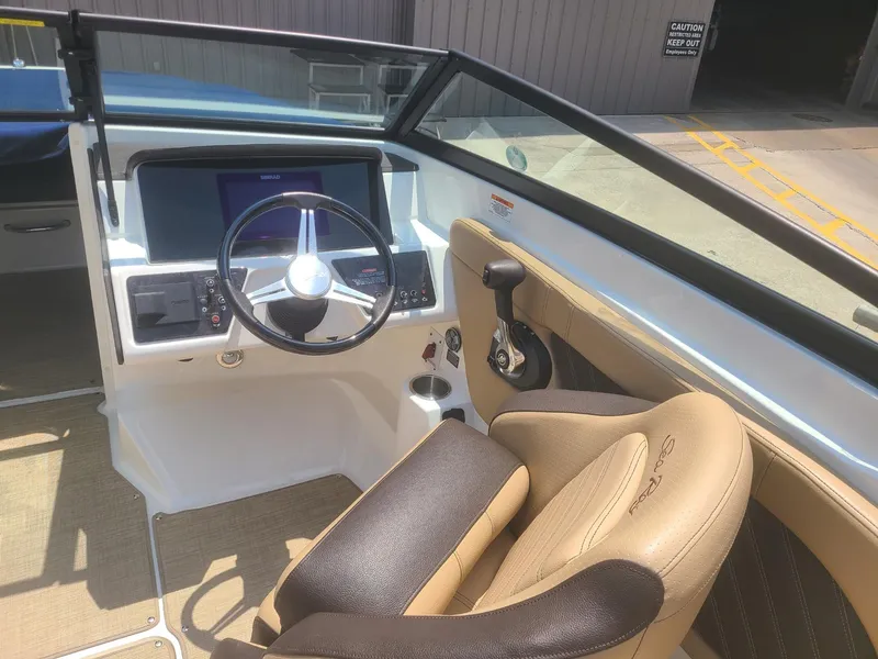 Slide: The Image of 2020 Sea Ray SPX 230 boat cockpit with steering wheel and control panel. - 4