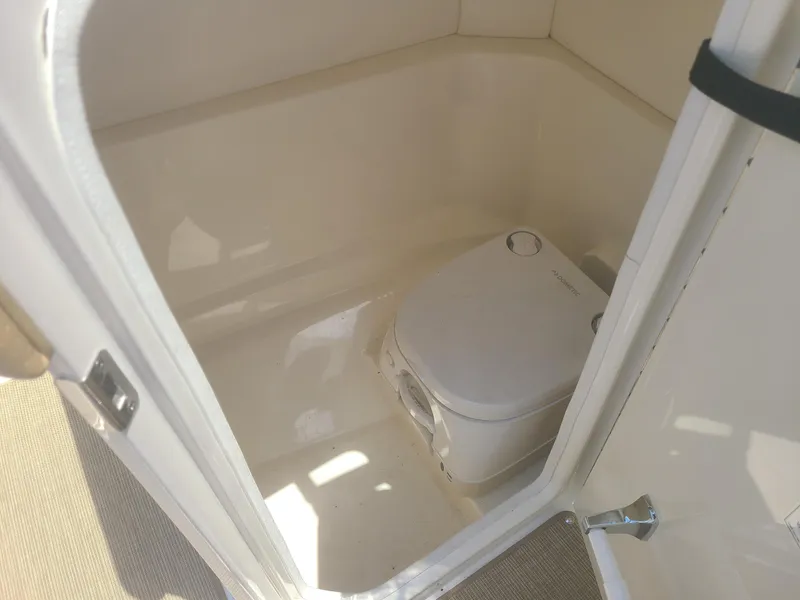 Slide: The Image of Interior of a 2020 Sea Ray SPX 230 boat featuring a compact marine toilet. - 6