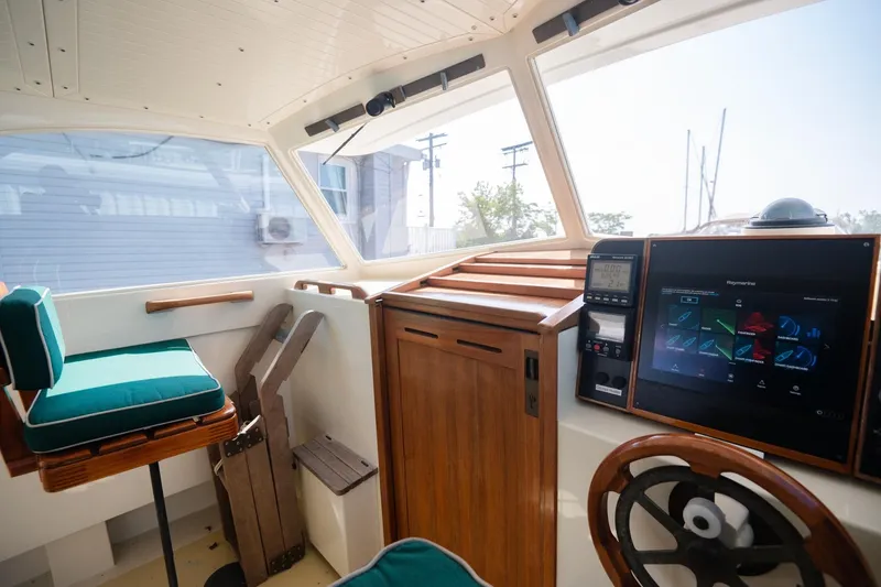 Slide: The Image of Interior of 1997 Belkov Picnic Express boat with modern navigation system and wooden accents. - 12
