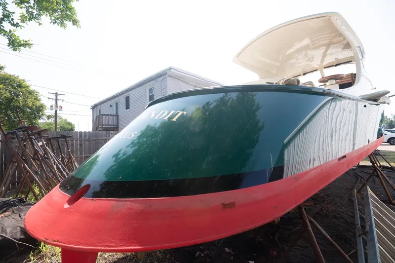 Slide: The Image of 1997 Belkov Picnic Express boat with green and red hull, docked outdoors. - 20