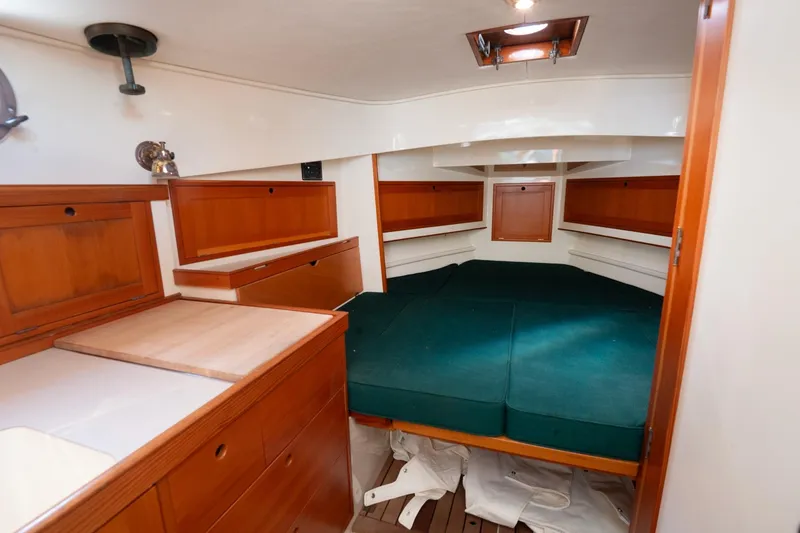 Slide: The Image of Interior of 1997 Belkov Picnic Express boat with wooden cabinetry and green cushions. - 3