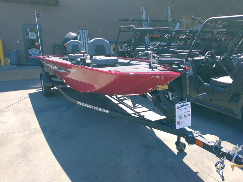 The Image of 2025 Tracker Panfish 17 boat on trailer, red color, parked outdoors. - 0