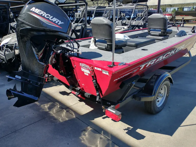 Slide: The Image of 2025 Tracker Panfish 17 boat in showroom, red exterior, on trailer. - 2