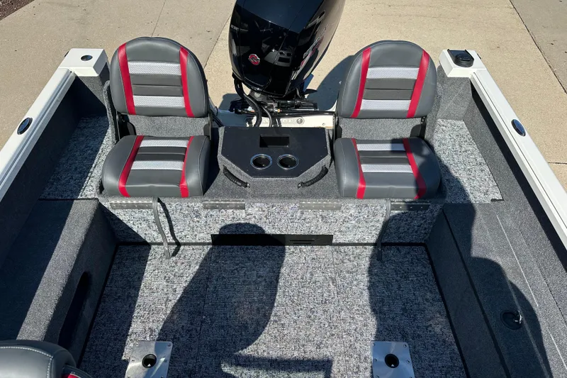 Slide: The Image of 2025 Ranger VS1882SC Angler boat interior with gray and red seating, motor, and carpeted flooring. - 10