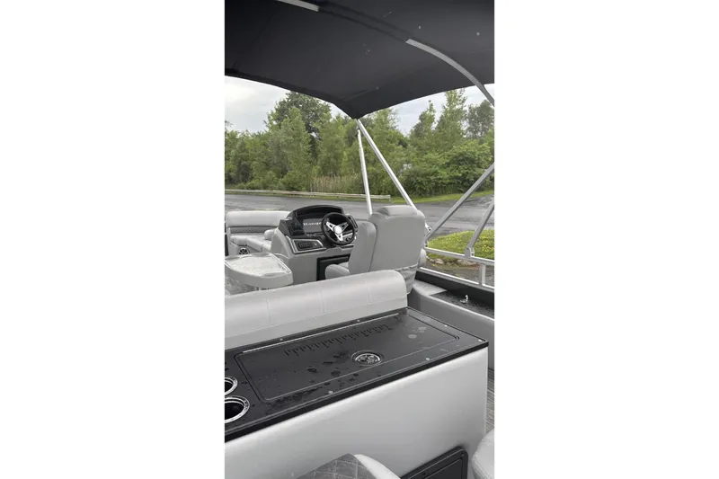 Slide: The Image of The image shows the cockpit of a Ranger Reata 220FC boat with gray seats and a black canopy. - 3