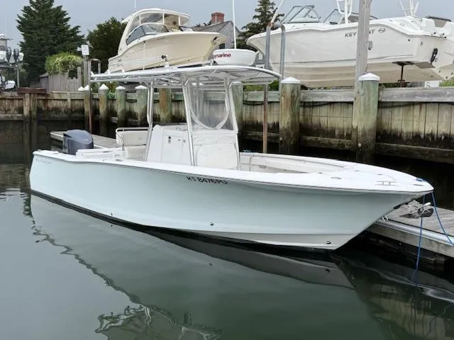 Slide: The Image of 2008 Southport 26 Center Console boat docked in a marina, calm water reflection. - 0