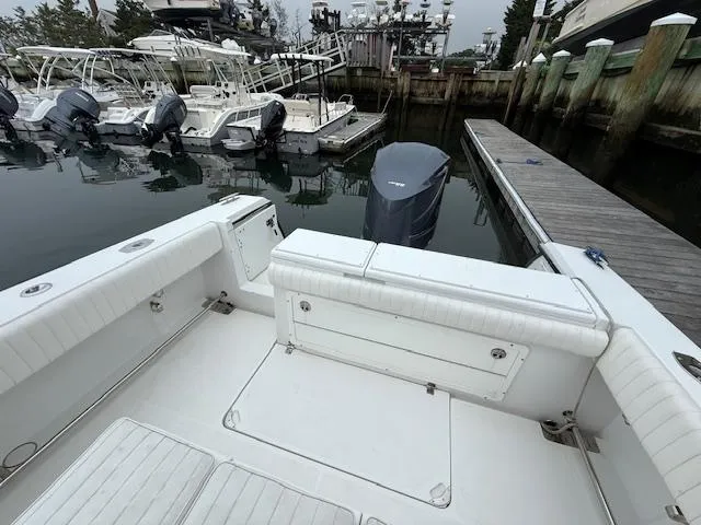Slide: The Image of 2008 Southport 26 Center Console boat docked at marina with outboard motor. - 11