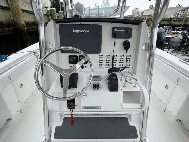 Slide: The Image of 2008 Southport 26 Center Console boat dashboard with Raymarine electronics and steering wheel. - 12