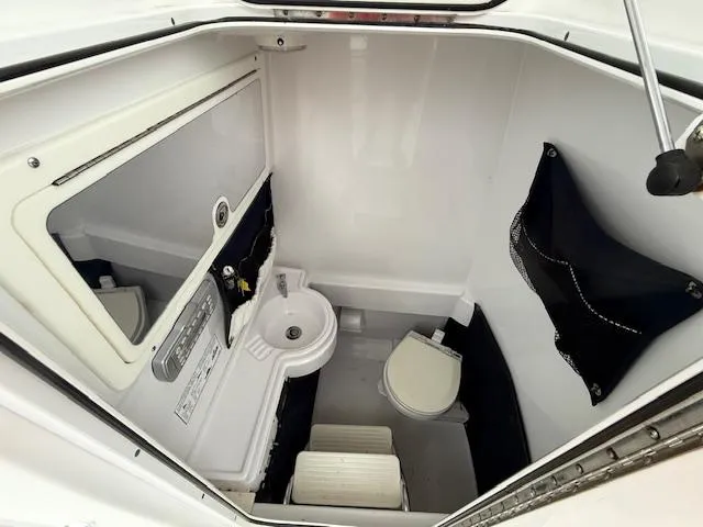 Slide: The Image of 2008 Southport 26 Center Console boat interior with sink and toilet. - 13