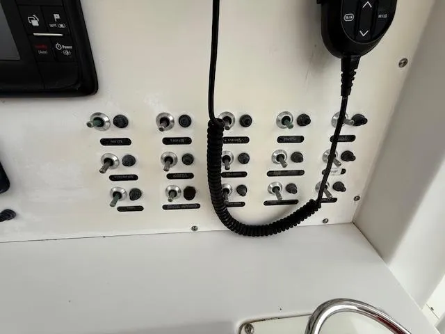 Slide: The Image of Control panel of a 2008 Southport 26 Center Console boat with switches and radio. - 17