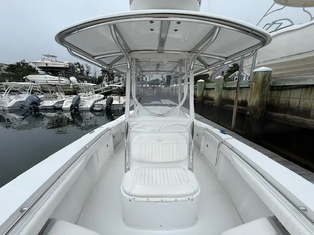 Slide: The Image of 2008 Southport 26 Center Console boat docked at marina, featuring spacious seating and T-top. - 7