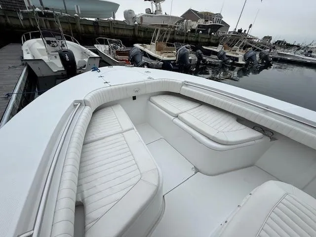 Slide: The Image of 2008 Southport 26 Center Console boat with white seating at a marina. - 9